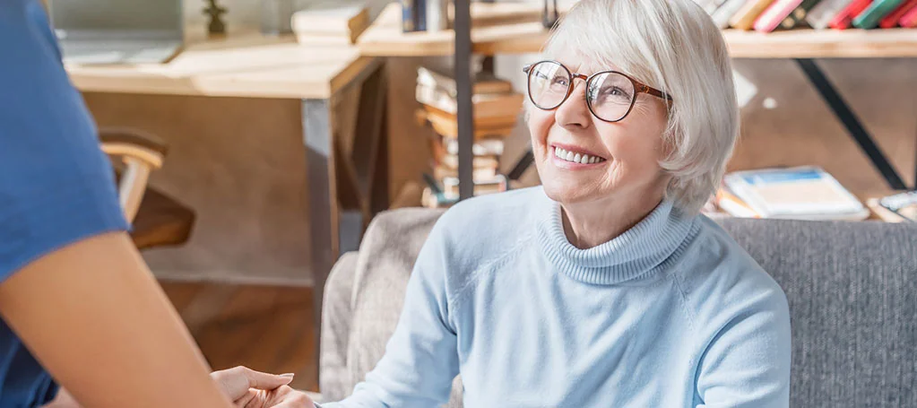 caregiver helping senior woman