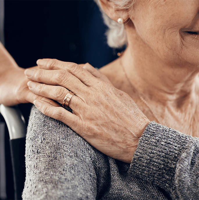 woman with hand on shoulder