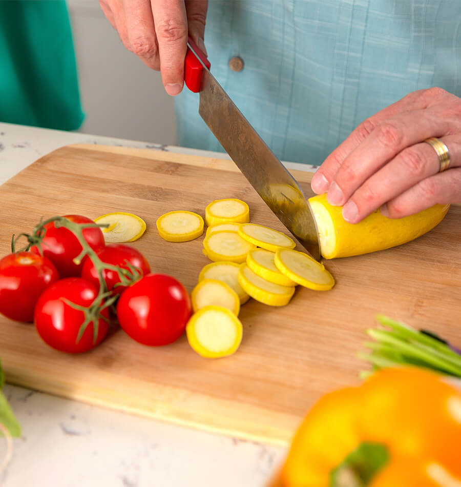 Close up of woman chopping vegetables